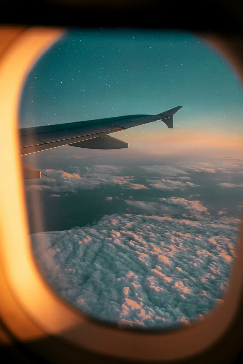 View through an airplane window at dusk